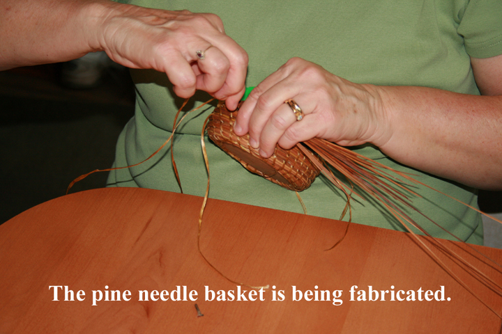 A pine needle basket is being fabricated.